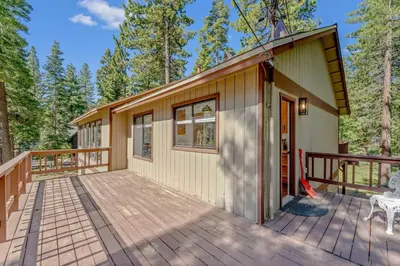 a home with a deck and a house at Modern 3BR Carnelian Bay Retreat in Carnelian Bay