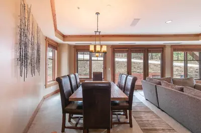 a dining room with a table and a couch at Big Horn Lodge 206 by East West in Truckee