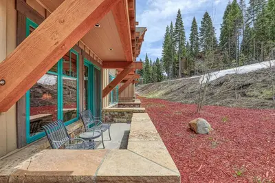 two chairs and a table on a porch of a house at Big Horn Lodge 208 by East West Hospitality in Truckee