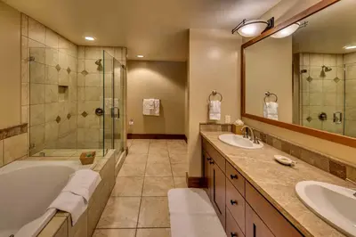 a bathroom with two sinks and a tub and a shower at Big Horn Lodge 309 by East West Hospitality in Truckee