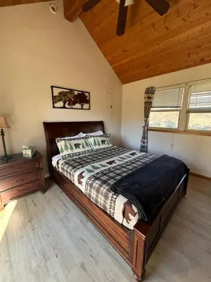 a bedroom with a large bed in a room at Sequoia River Front Cabins in Three Rivers
