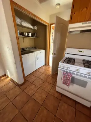 a kitchen with a stove top oven in a room at Sequoia River Front Cabins in Three Rivers