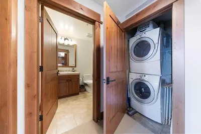 a laundry room with a washer and dryer in it at Big Horn Lodge 401 by East West Hospitality in Truckee