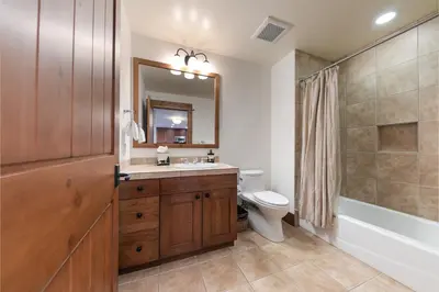 a bathroom with a sink and a toilet and a mirror at Big Horn Lodge 401 by East West Hospitality in Truckee