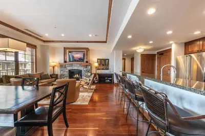 a kitchen and living room with a table and chairs at Big Horn Lodge 401 by East West Hospitality in Truckee