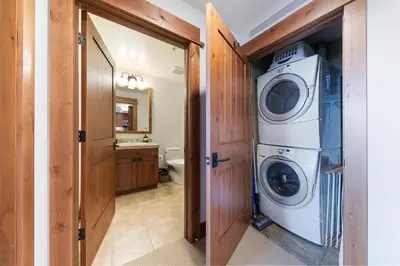 a laundry room with a washer and dryer in it at Big Horn Lodge 401 by East West Hospitality in Truckee