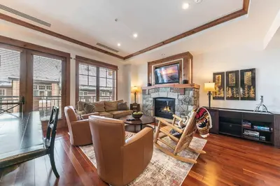 a living room with a couch and a fireplace at Big Horn Lodge 401 by East West Hospitality in Truckee