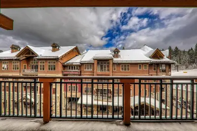 a large house with snow on top of it at Big Horn Lodge 401 by East West Hospitality in Truckee