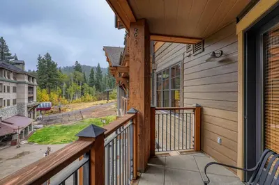a balcony of a house with a view at Big Horn Lodge 409 by East West Hospitality in Truckee