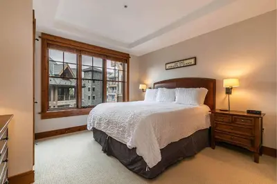 a bedroom with a large bed and a window at Big Horn Lodge 409 by East West Hospitality in Truckee