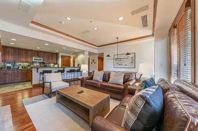 a living room with a couch and a table at Big Horn Lodge 404 by East West Hospitality in Truckee