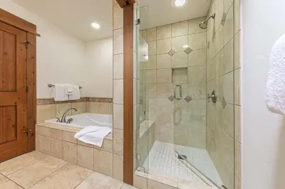 a bathroom with a shower and a bath tub at Big Horn Lodge 404 by East West Hospitality in Truckee