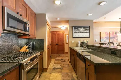 a kitchen with a sink and a stove top oven at Big Horn Lodge 310 by East West Hospitality in Truckee
