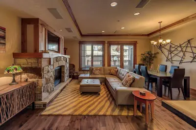 a living room with a couch and a fireplace at Big Horn Lodge 403 by East West Hospitality in Truckee