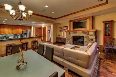 a living room with a couch and a fireplace at Big Horn Lodge 403 by East West Hospitality in Truckee