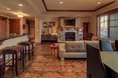 a living room with a couch and a fireplace at Big Horn Lodge 403 by East West Hospitality in Truckee