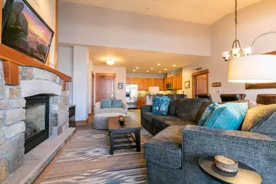 a living room with a couch and a fireplace at Big Horn Lodge 501 by East West Hospitality in Truckee