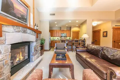 a living room with a couch and a fireplace at Big Horn Lodge 510 by East West Hospitality in Truckee