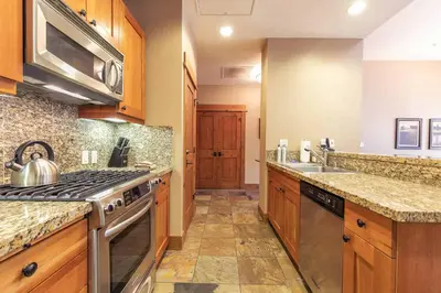 a kitchen with a stove and a sink at Big Horn Lodge 510 by East West Hospitality in Truckee