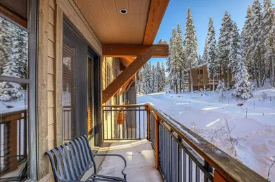 a balcony with a view of a snow covered yard at Big Horn Lodge 410 by East West Hospitality in Truckee