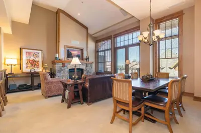 a living room with a table and a dining room at Big Horn Lodge 511 by East West Hospitality in Truckee