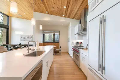 a kitchen with white counters and a wooden ceiling at Boulders 15136 by East West Hospitality in Truckee