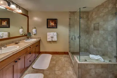 a bathroom with a shower and a sink at Catamount Lodge 103 by East West Hospitality in Truckee