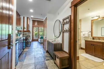 a bathroom with a sink and a mirror at Catamount Lodge 105 by East West Hospitality in Truckee