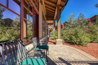 a porch with two benches on a house at Catamount Lodge 105 by East West Hospitality in Truckee