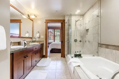 a bathroom with a tub and a shower and a sink at Catamount Lodge 201B by East West Hospitality in Truckee