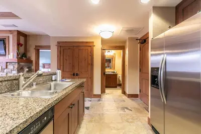 a kitchen with a sink and a refrigerator at Catamount Lodge 201B by East West Hospitality in Truckee