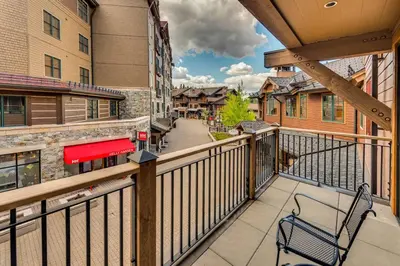 a balcony with a bench on a balcony at Catamount Lodge 204 by East West Hospitality in Truckee