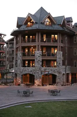 a large building with tables in front of it at Catamount Lodge 204A by East West Hospitality in Truckee