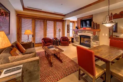 a living room with a couch and a table at Catamount Lodge 211 by East West Hospitality in Truckee
