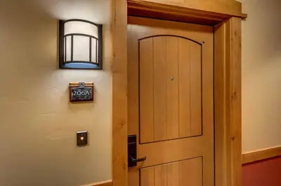 a door in a room with a sign on it at Catamount Lodge 206A by East West Hospitality in Truckee
