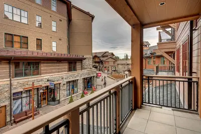 a balcony with a view of a street at Catamount Lodge 206B by East West Hospitality in Truckee