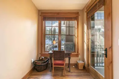 a dining room with a table and a window at Catamount Lodge 308 by East West Hospitality in Truckee