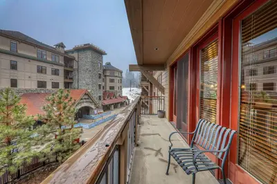 a balcony with two benches on a building at Catamount Lodge 305B by East West Hospitality in Truckee