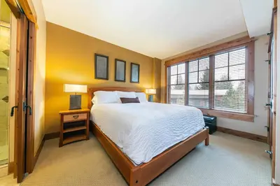 a bedroom with a large bed and a window at Catamount Lodge 305B by East West Hospitality in Truckee