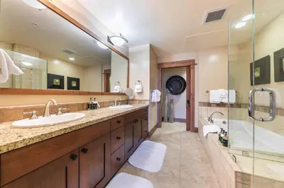 a large bathroom with two sinks and a shower at Catamount Lodge 305B by East West Hospitality in Truckee
