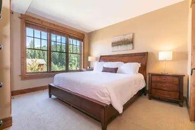 a bedroom with a large bed and a window at Catamount Lodge 301 by East West Hospitality in Truckee