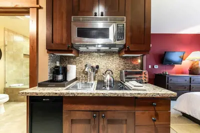 a kitchen with a sink and a microwave at Catamount Lodge 305A by East West Hospitality in Truckee