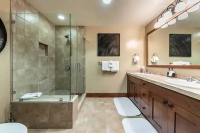 a bathroom with a shower and a sink at Catamount Lodge 305A by East West Hospitality in Truckee
