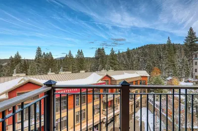 a view from the balcony of a resort with snow at Catamount Lodge 401 by East West Hospitality in Truckee