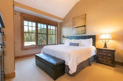 a bedroom with a large bed and a window at Catamount Lodge 401B by East West Hospitality in Truckee