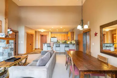 a living room with a couch and a table at Catamount Lodge 401B by East West Hospitality in Truckee