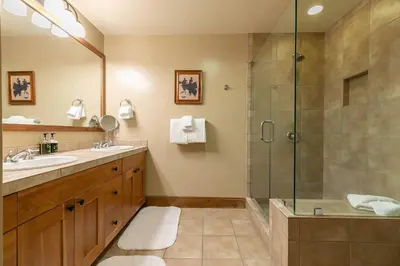 a bathroom with a shower and a sink at Catamount Lodge 401A by East West Hospitality in Truckee