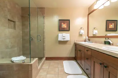 a bathroom with a shower and a sink at Catamount Lodge 404 by East West Hospitality in Truckee