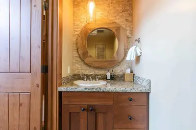 a bathroom with a sink and a mirror at Catamount Lodge 408 by East West Hospitality in Truckee