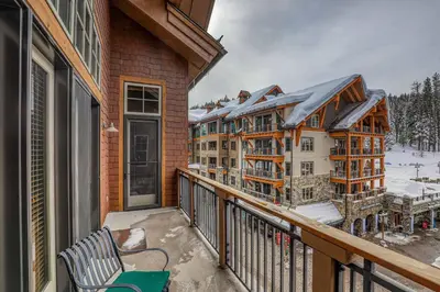 a balcony with a view of a resort at Catamount Lodge 408 by East West Hospitality in Truckee